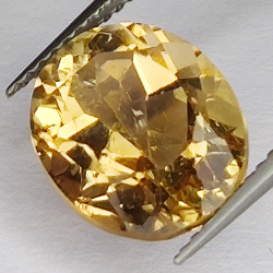 6.67ct Champagne Topaz taglio ovale 12.1x10.1mm